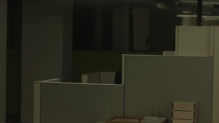 A cubicle with a chair in an office