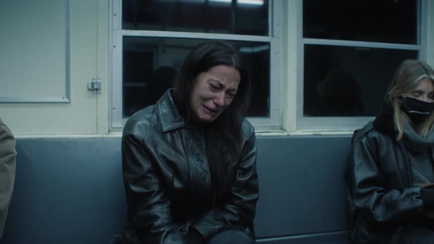 A woman cries indoors