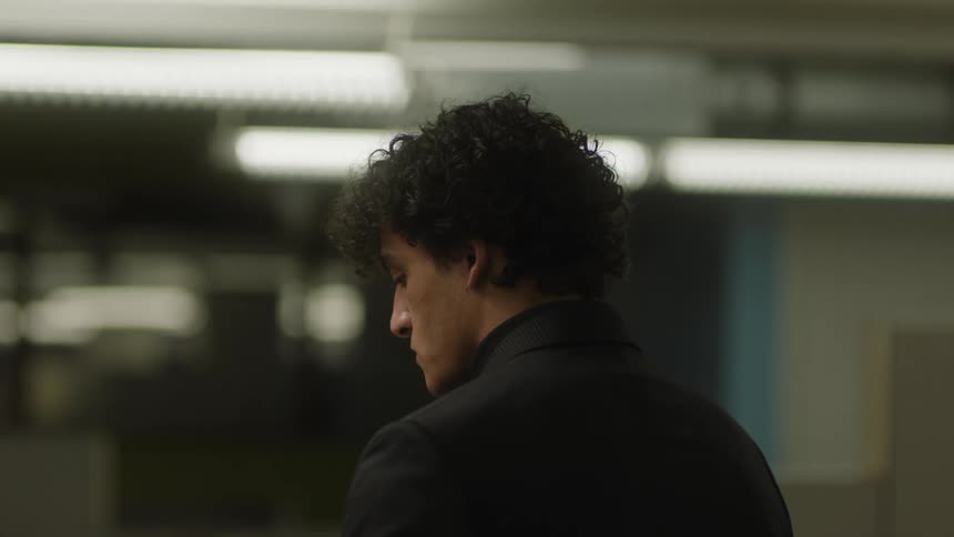 A man in an office walks away