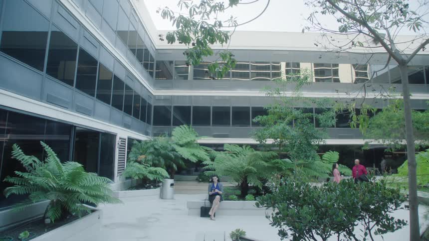 People sitting and talking while outdoors on a campus