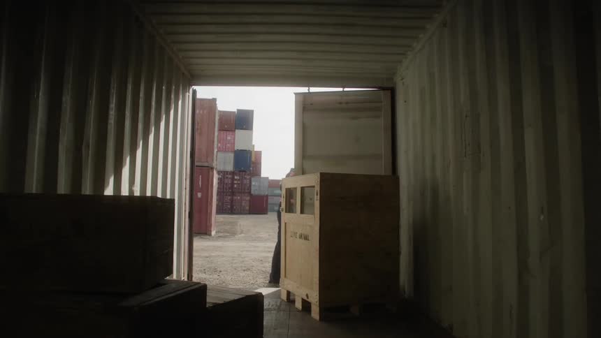 A man opens the doors on the storage container