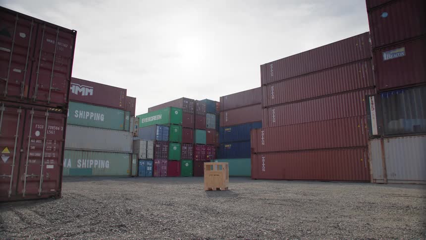 Wooden box in the center of an openair location with distribution containers around it