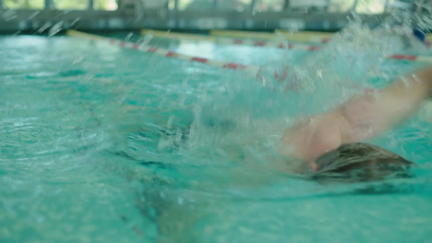 Man swimming in a lane of a pool