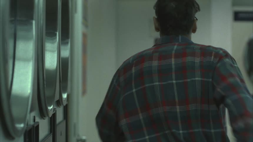 A man running to the bathroom on a laundromat