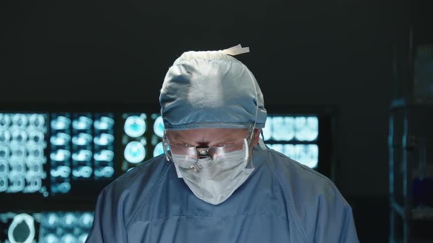 A surgeon walks in and performs surgery on a patient