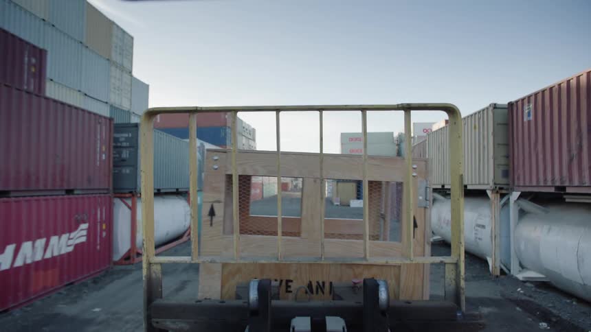 The forklift is carrying a wooden crate