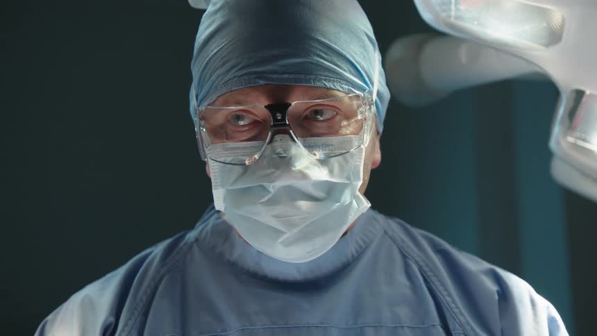 A surgeon is looking down in the operating room