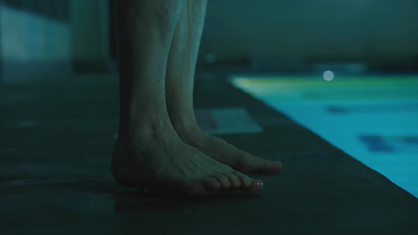 A swimmer gets out of the pool