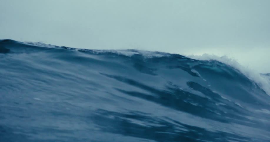 A large white capped wave rolls over the camera