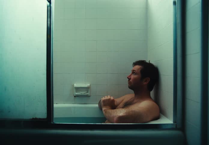 A man is relaxing in the tub