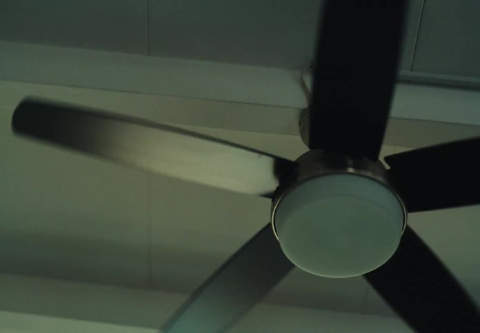 A ceiling fan spins