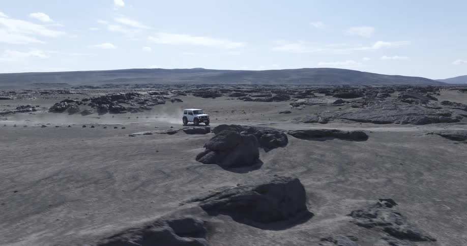 An atv driving on a desert road