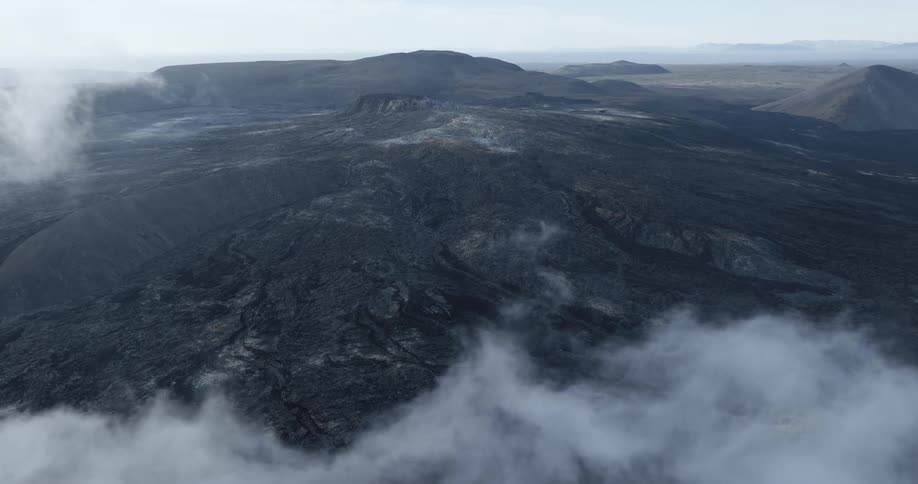 Aerial panorama of craters and volcano with clouds around on a morning