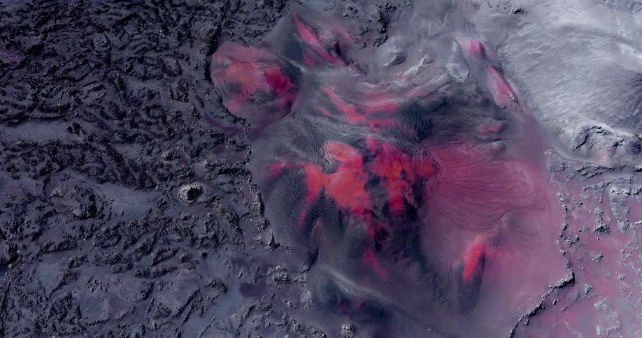 Aerial panorama of a ground with red and grayish volcanic craters