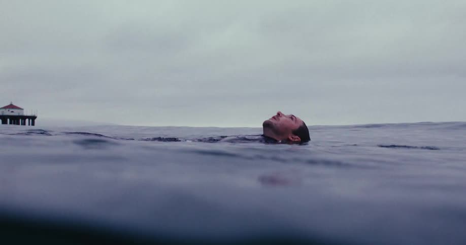 Male floating on his back in the ocean