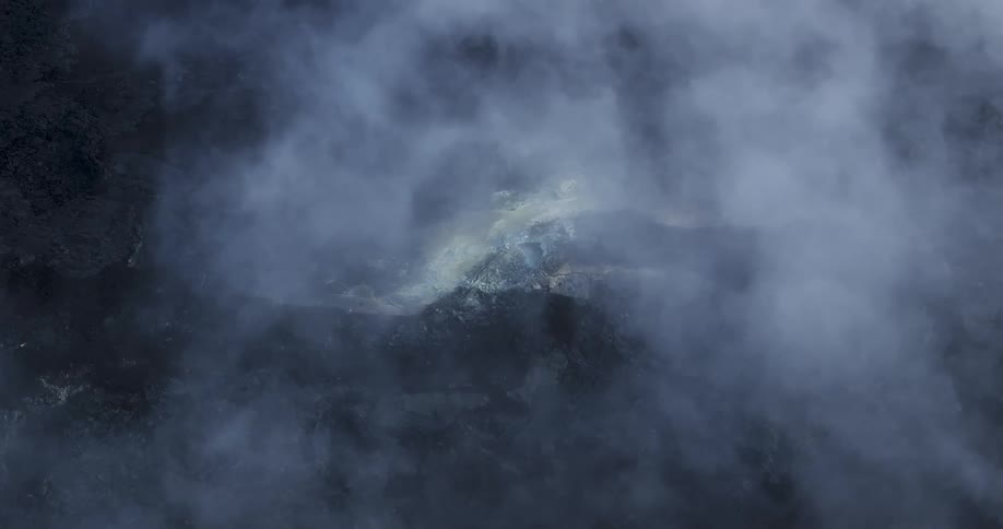 Aerial view of a mountain range and forest with a large blanket of fog over it