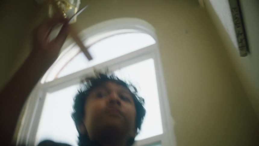 Little boy climbing the stairs and then throwing a cardboard plane into the air
