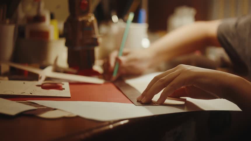 Close up of a boy doing arts and crafts at home