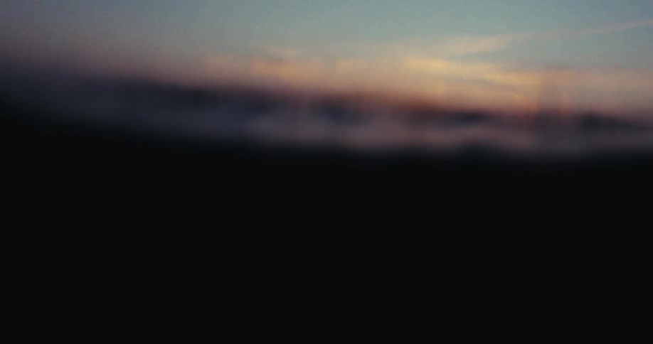 An ocean scene with gentle waves at sunset