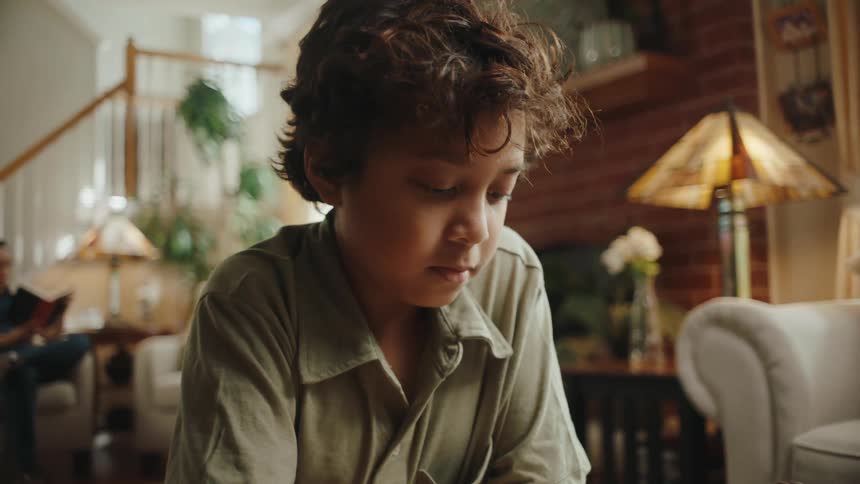 Portrait of a little boy concentrating on drawing