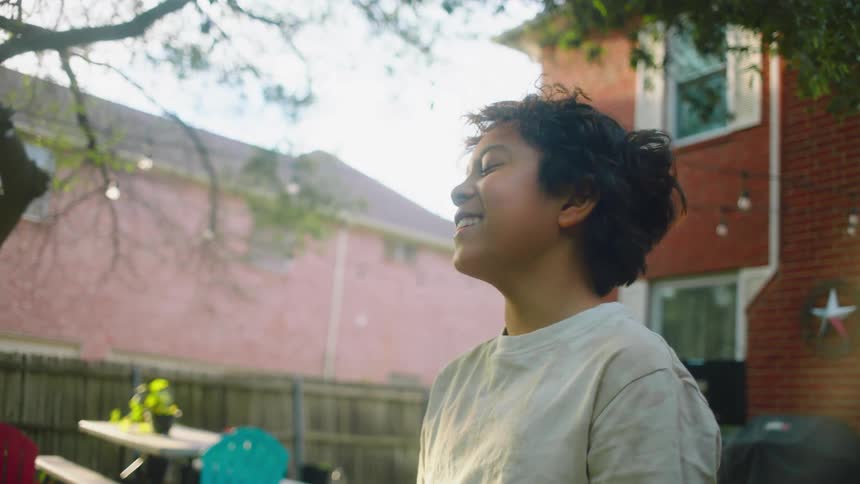 Portrait of a boy in the backyard smiling
