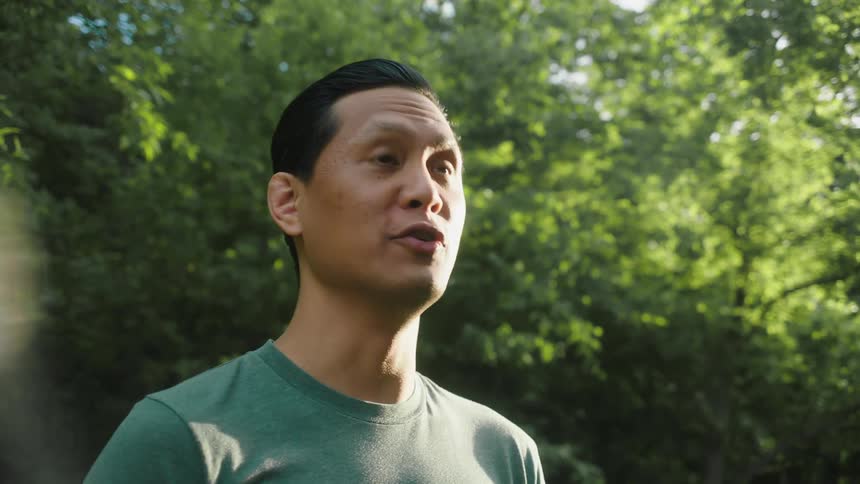 Portrait of a man in an outdoor wooded environment talking