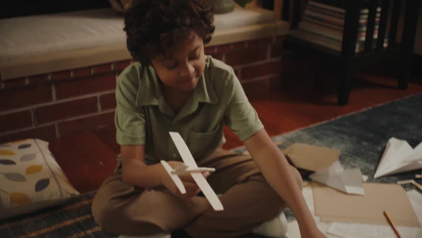 A young boy holds toy planes