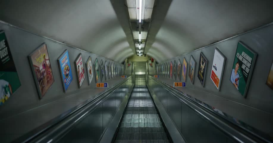 View from inside an escalator that is going up in a subway station