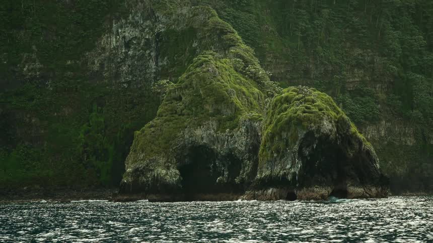 The green mountains line the shore