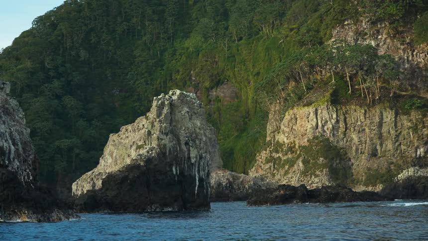 Ocean water flows near a coast and islets