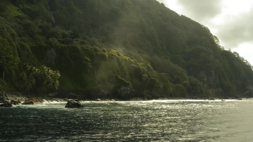 Ocean landscape reaching rocky wooded shore