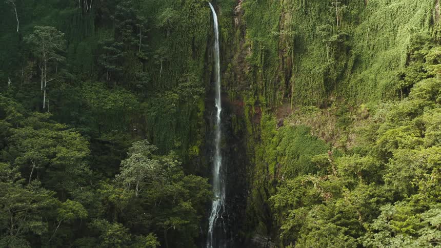 Aerial view of a waterfall cascading down a steep clif