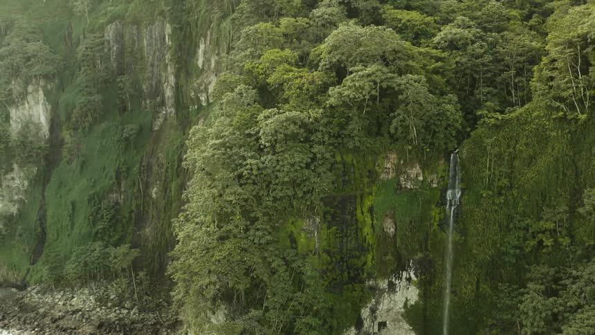 Aerial view of a waterfall cascading down a steep cliff