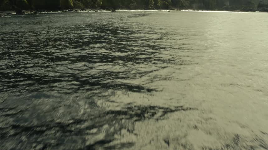 A view of a great sea that extends to the coast of a land with a huge mountain