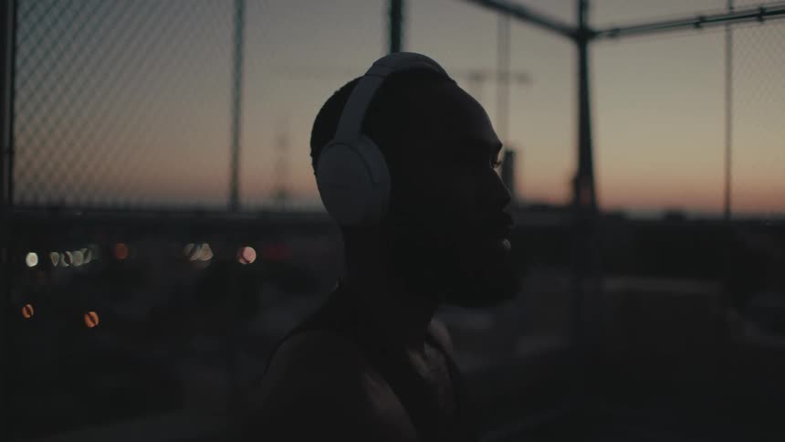 A man is listening to his headphones outside