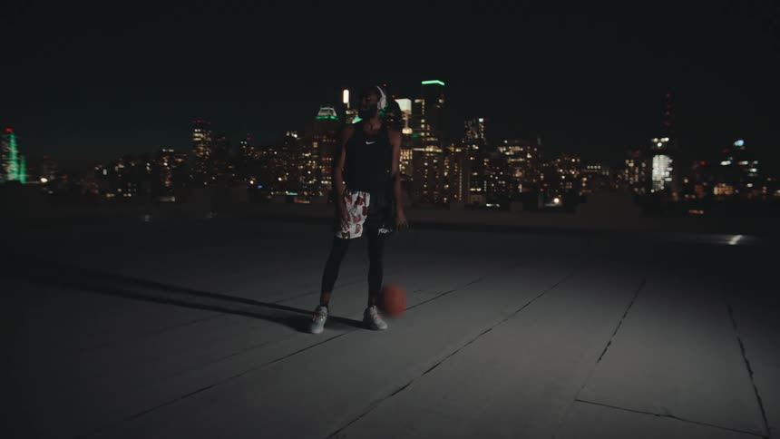 A man is dribbling a basketball on the roof