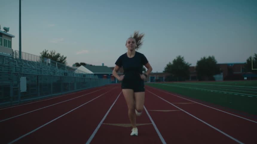 Woman running on an athletics track