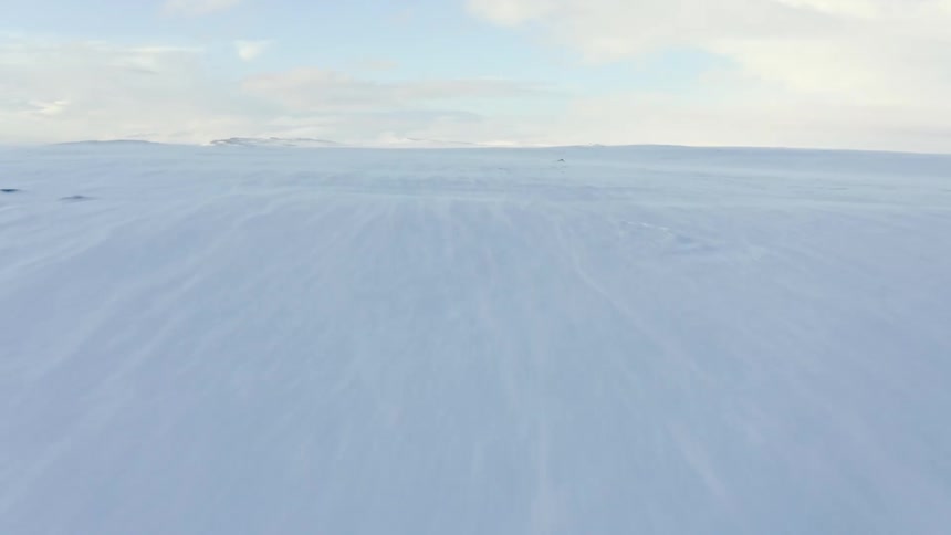 An aerial view of a vast arctic snowcovered field