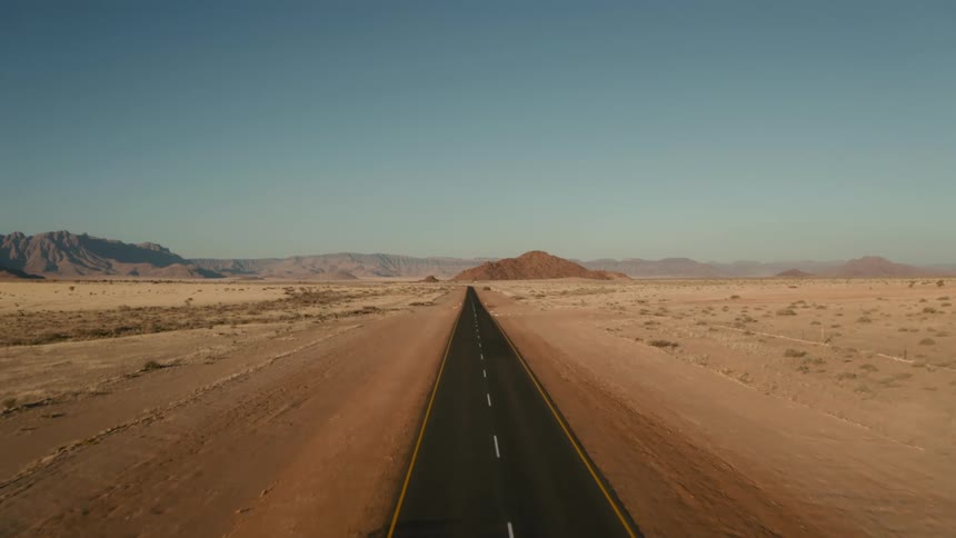 A road runs through a desert