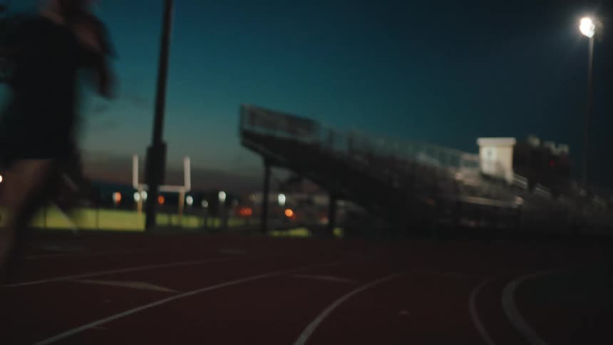 A woman is racing around the track