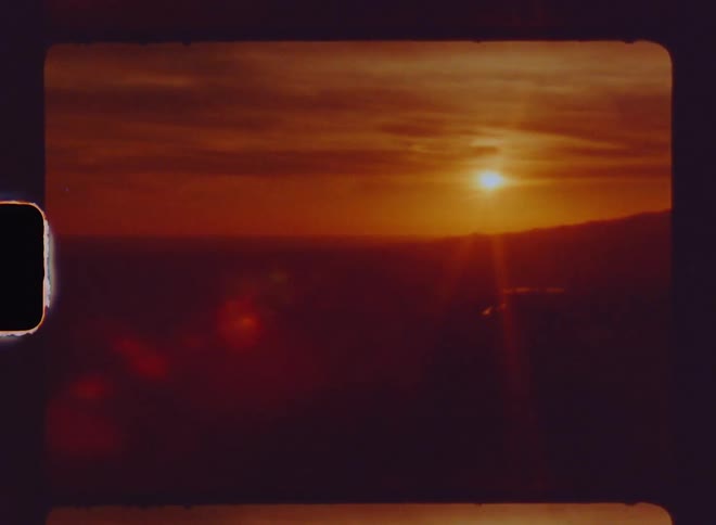 Panorama of an urban city with a red sun on the horizon