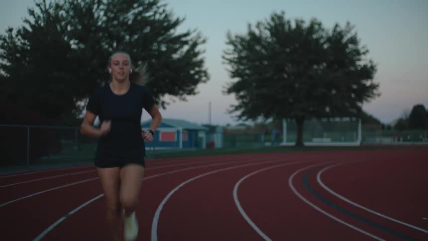 A woman is running on the track