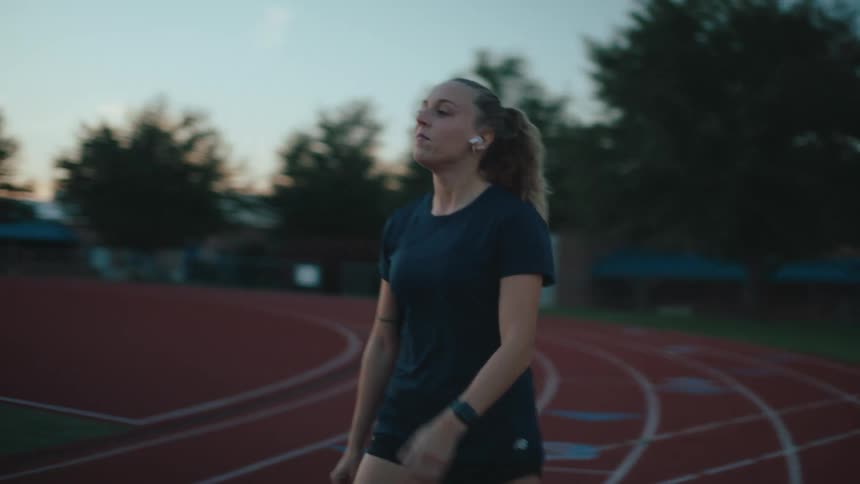 Woman runner walking on an athletics track on a morning