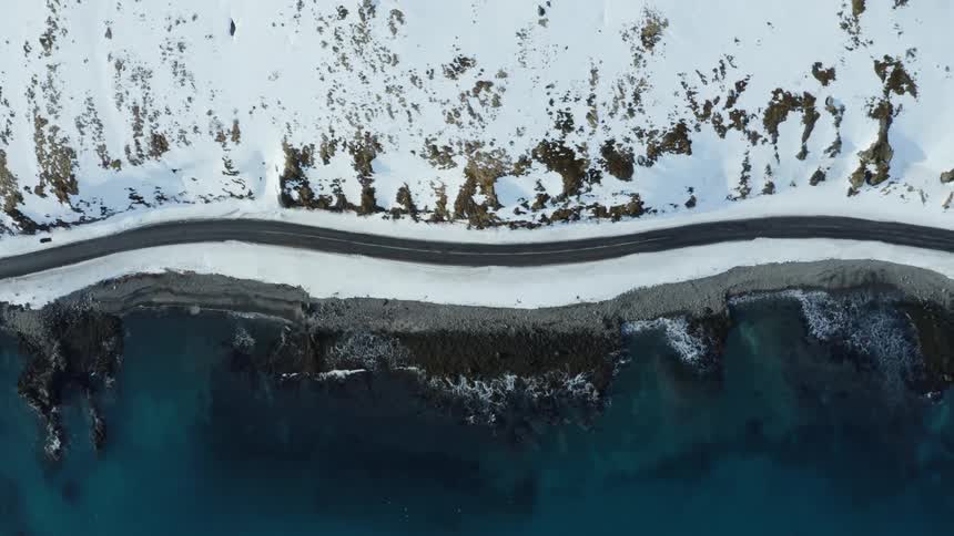 The road runs along the shoreline