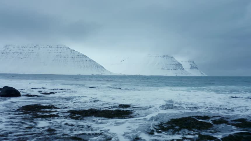 Waves crash against a rocky shore