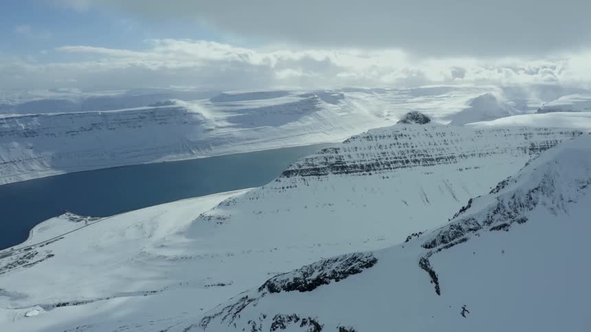 Aerial view of snow capped mountains and a river