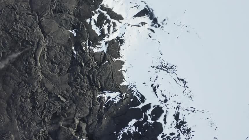 Aerial panorama of a soil with erosions and rock craters with snow
