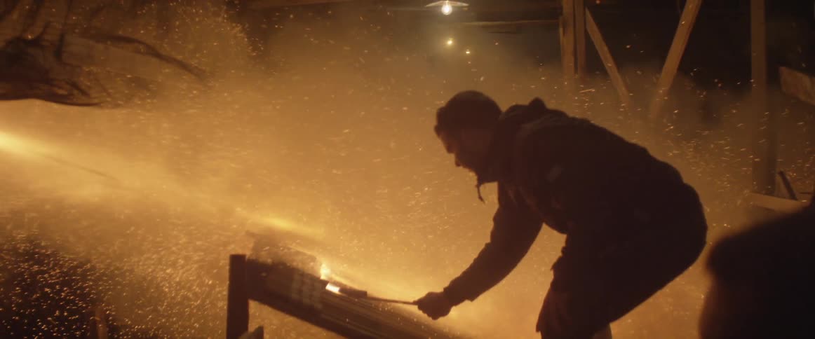 People setting off multiple fireworks at once with sparks everywhere