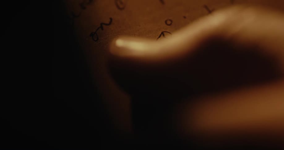 Person rubs finger across hand written text