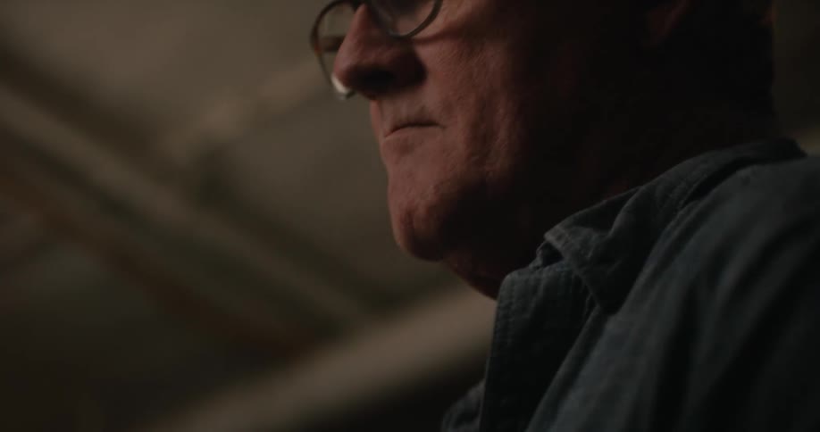 Portrait of a man indoors holding a piece of wood